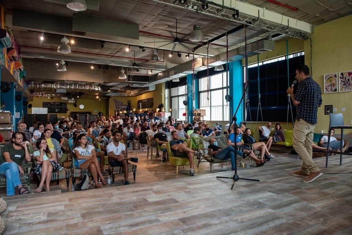 Dani addressing an audience at a bright, open event venue