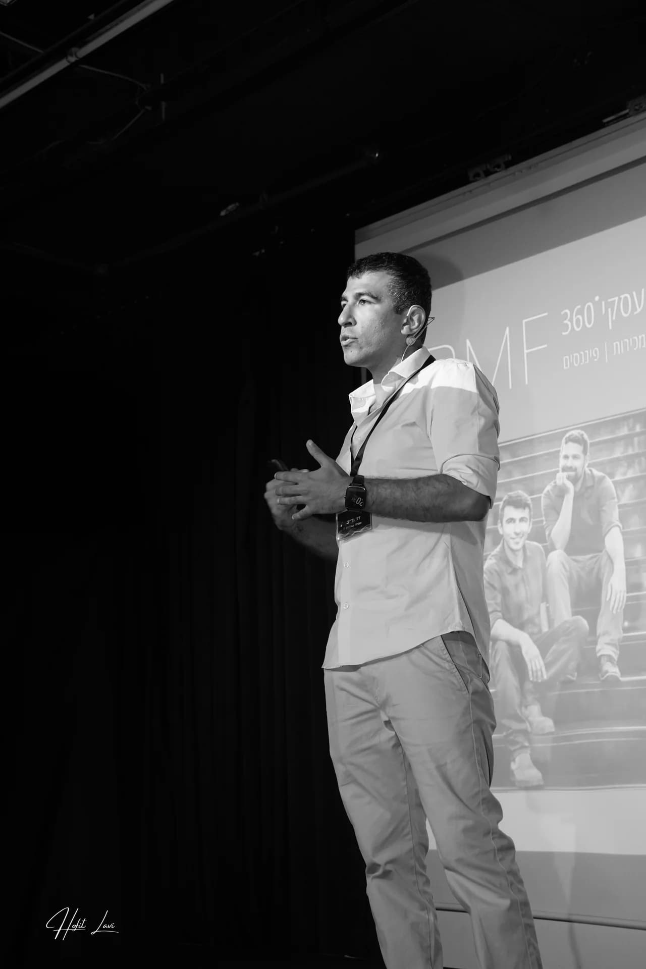 Black-and-white photograph of Dani speaking on stage